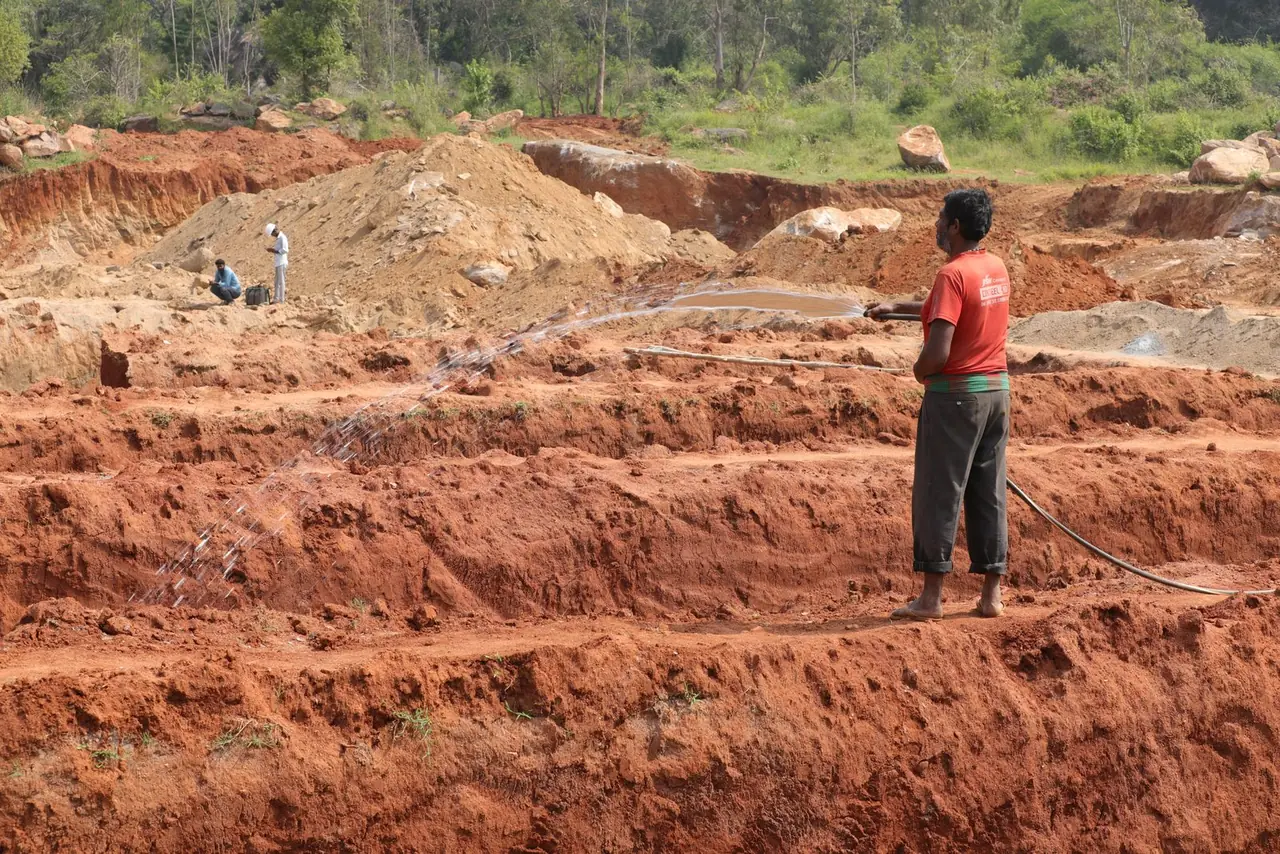 Red-earth foundation trenches being dug for the hostel block at Bachenahatti