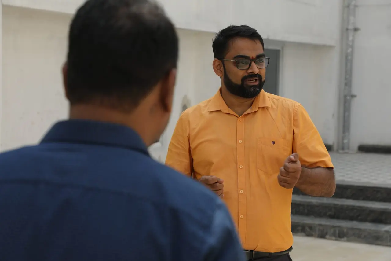 Dr Varun Murthy explaining the campus plan on the terrace of the new block