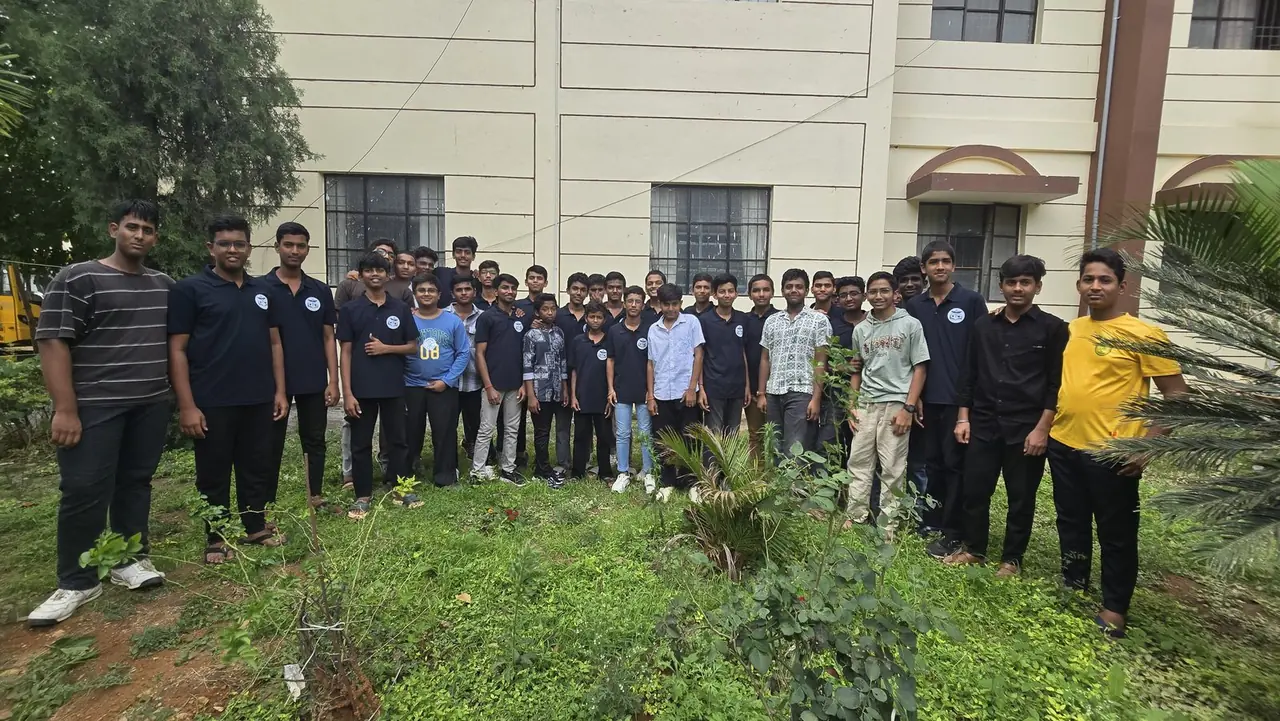 Students on the green grounds beside the Kodathi campus building