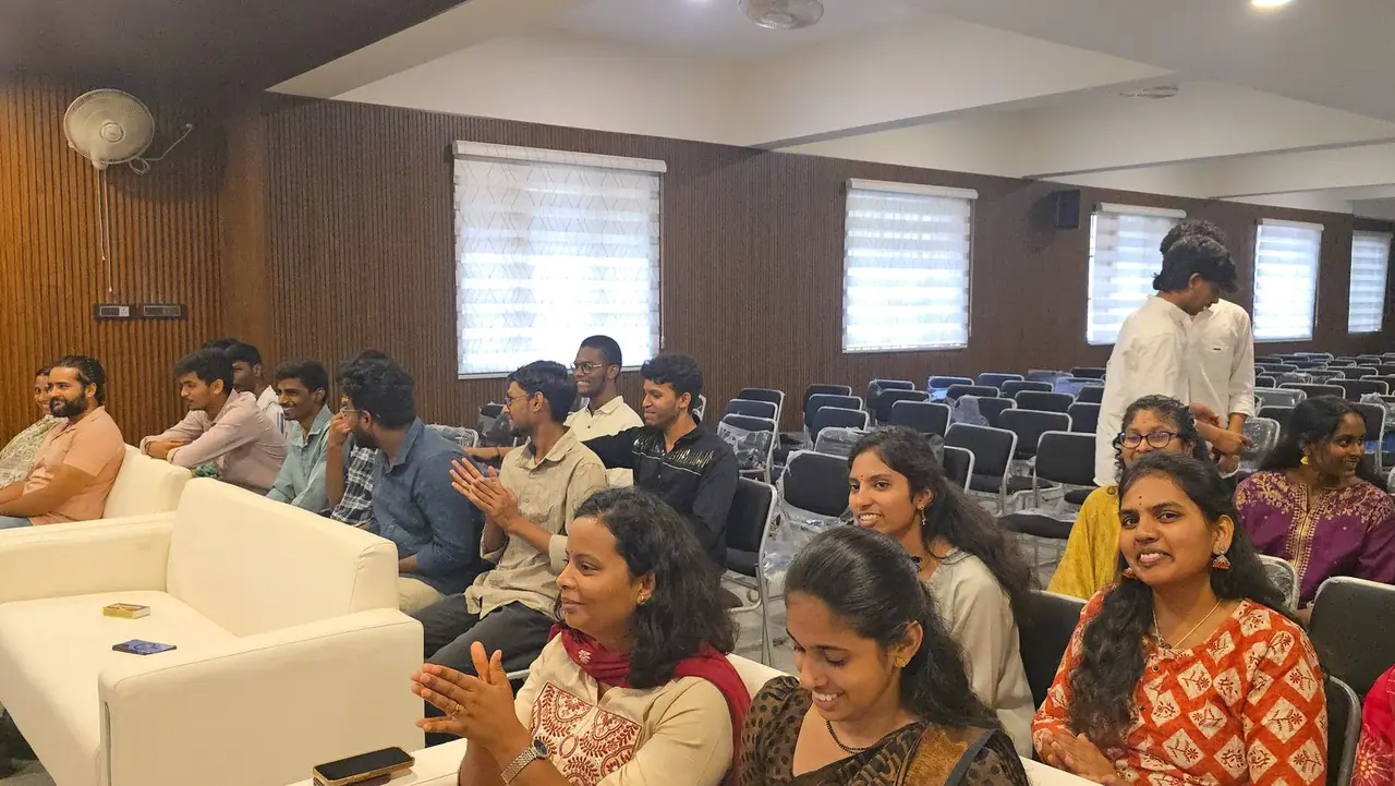 Parents and students applauding during a session in an auditorium