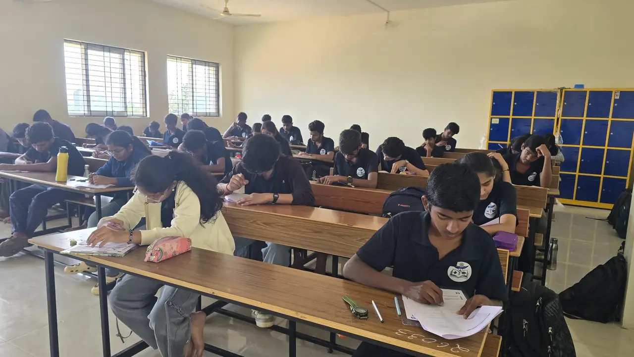 Students in a silent self-study block at RIMA, writing at long benches