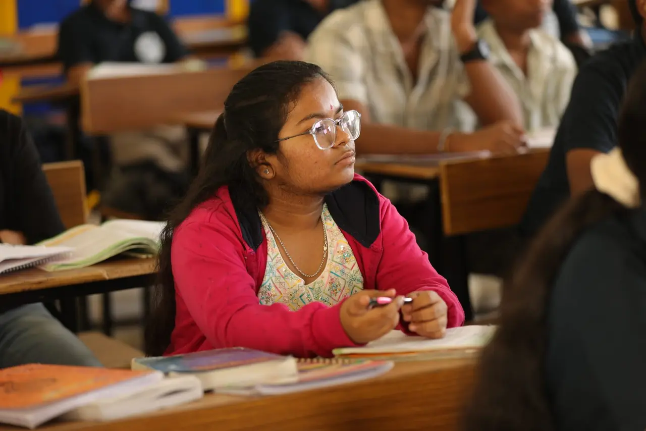 A PUC student listening closely during a NEET science class