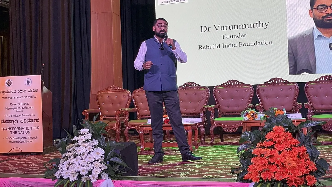 Dr Varun Murthy speaking to families at a Rebuild India town hall